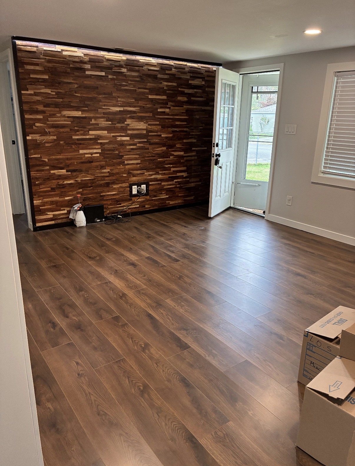 Living room with wood accent wall & laminate floors