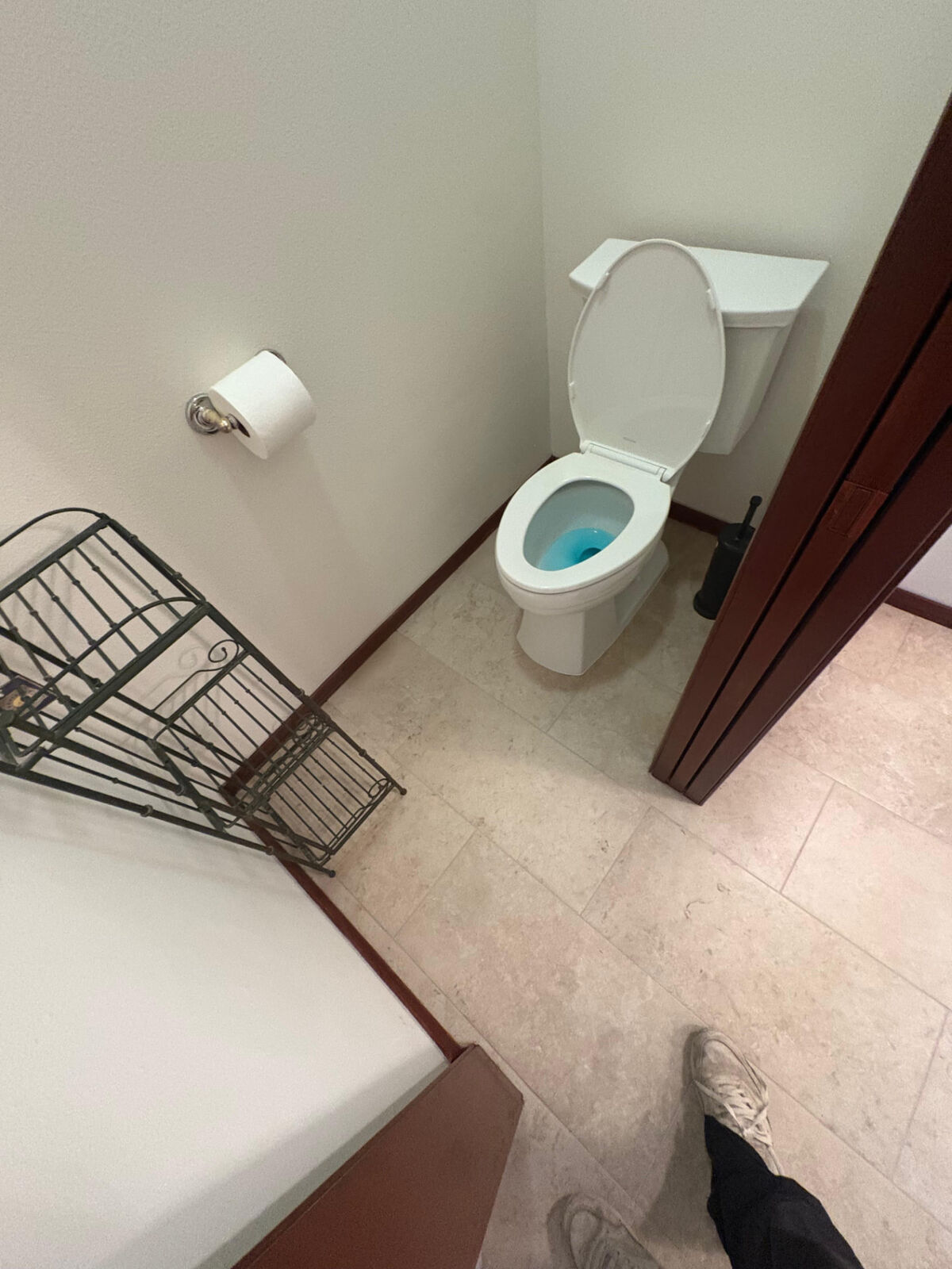 Toilet room with new tile floor, baseboards, and door casing
