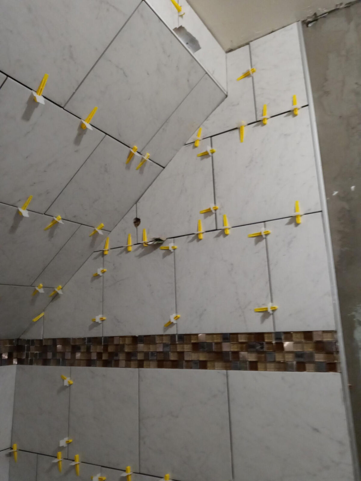 Angled-ceiling tile with glass mosaic band