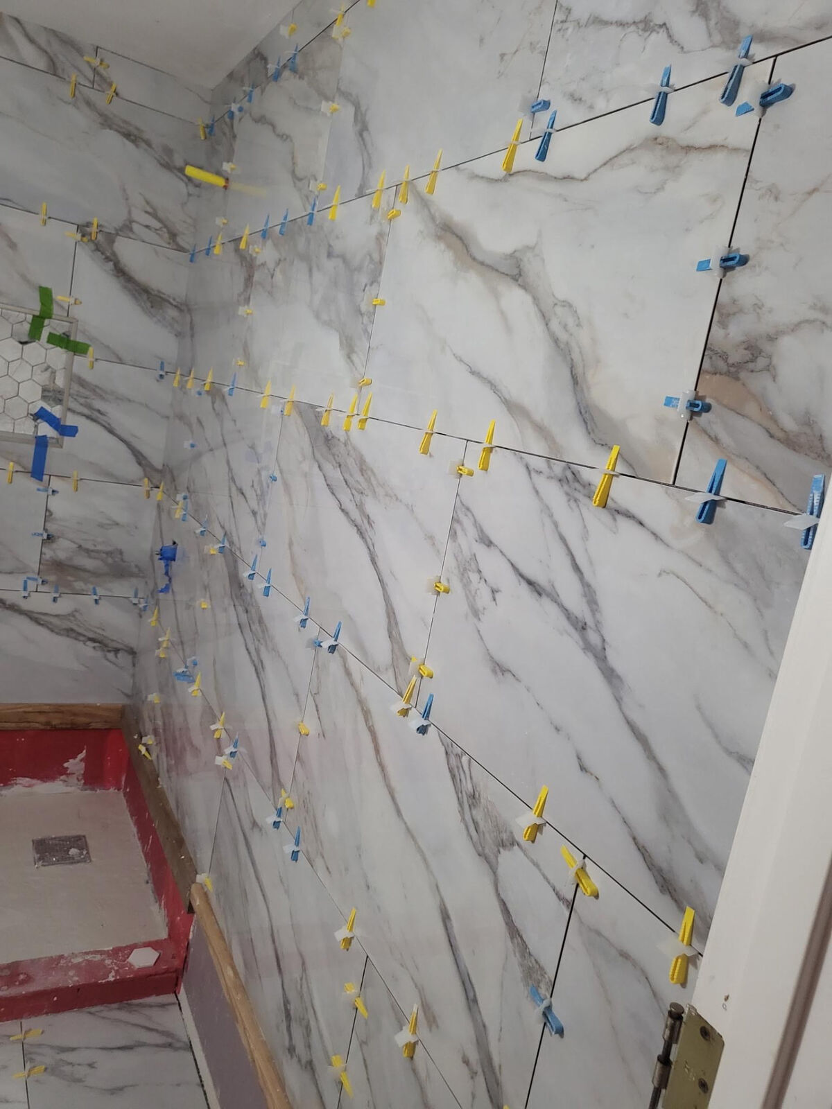 Large marble-look porcelain shower walls